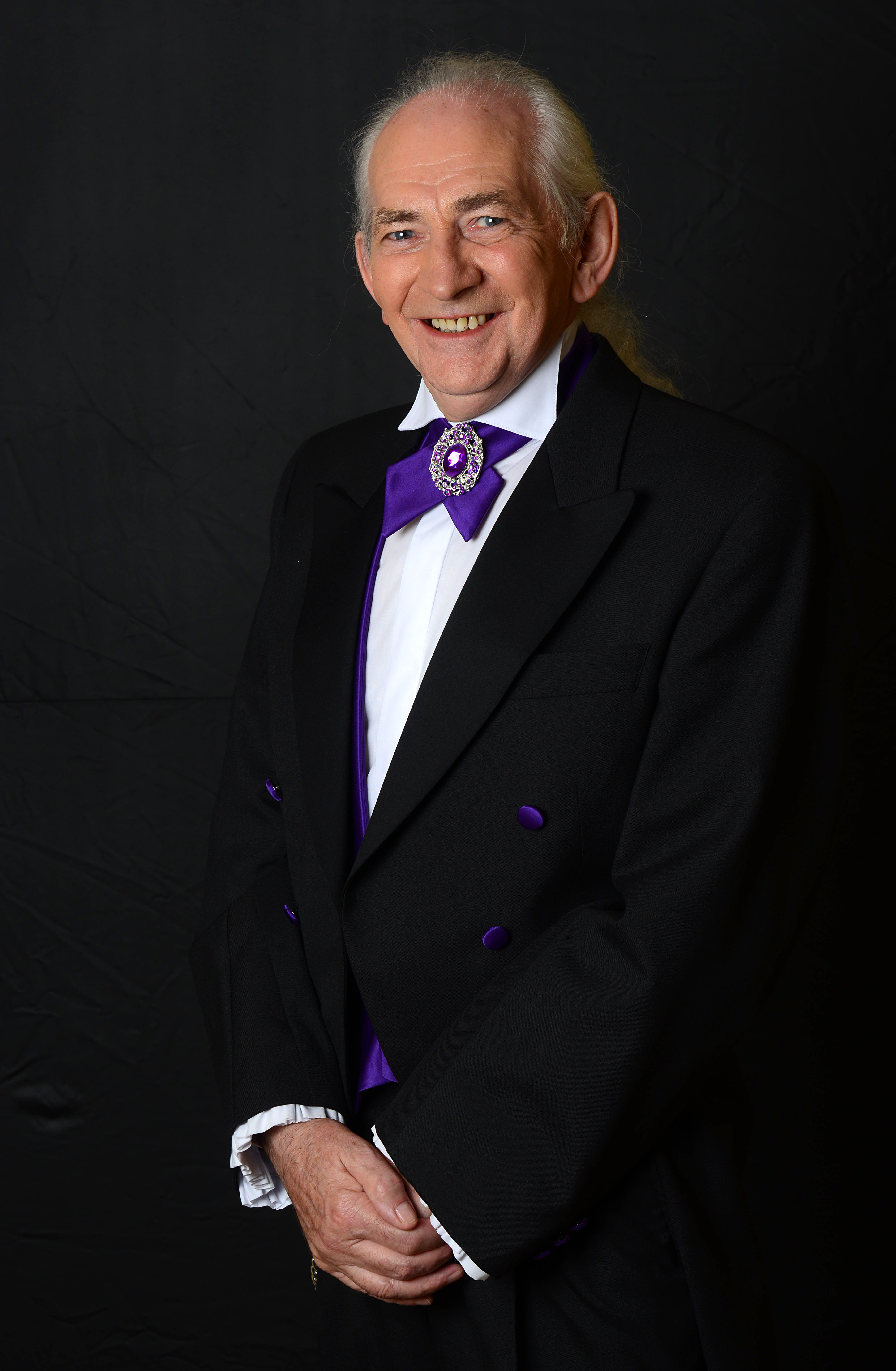 Pat Fallon on stage in formal dress